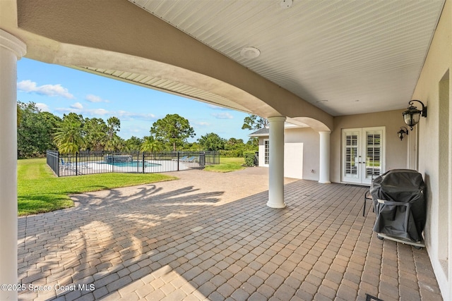 view of patio featuring french doors, fence, and grilling area