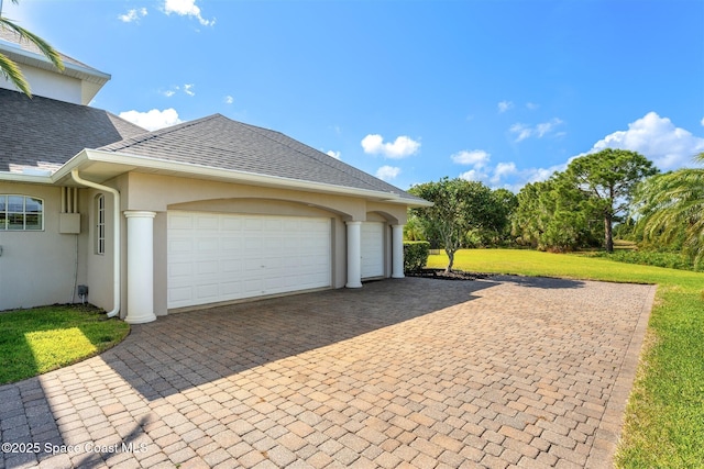 garage featuring decorative driveway