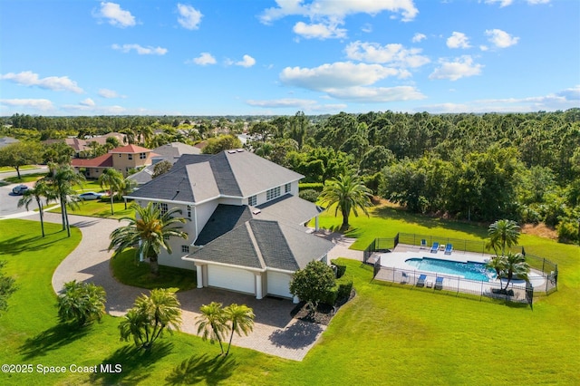 aerial view of property and surrounding area featuring a pool area