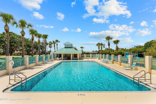 community pool featuring a patio, a gazebo, and fence