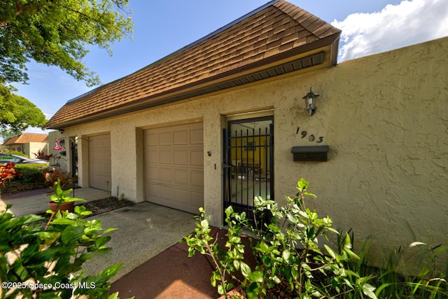 view of property exterior with roof with shingles and stucco siding