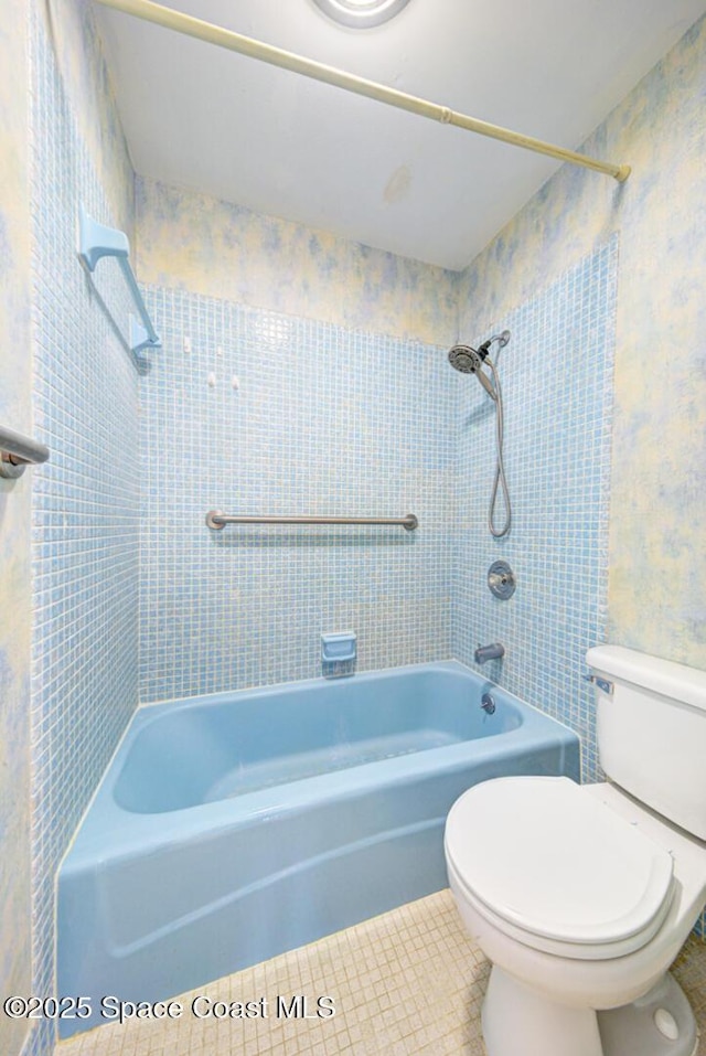 full bathroom with toilet, tile patterned flooring, and bathing tub / shower combination