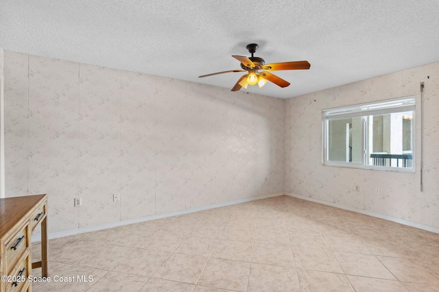 5801 N Banana River Blvd Unit 936, Cape Canaveral, FL 32920 - spare room with a textured ceiling, ceiling fan, wallpapered walls, and baseboards