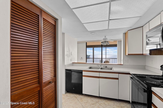 5801 N Banana River Blvd Unit 936, Cape Canaveral, FL 32920 - kitchen featuring light tile patterned floors, black appliances, light countertops, and a sink