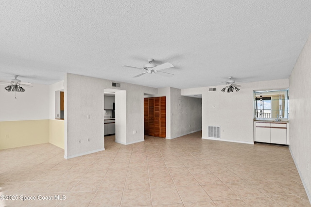 5801 N Banana River Blvd Unit 936, Cape Canaveral, FL 32920 - unfurnished living room featuring visible vents, ceiling fan, and a textured ceiling