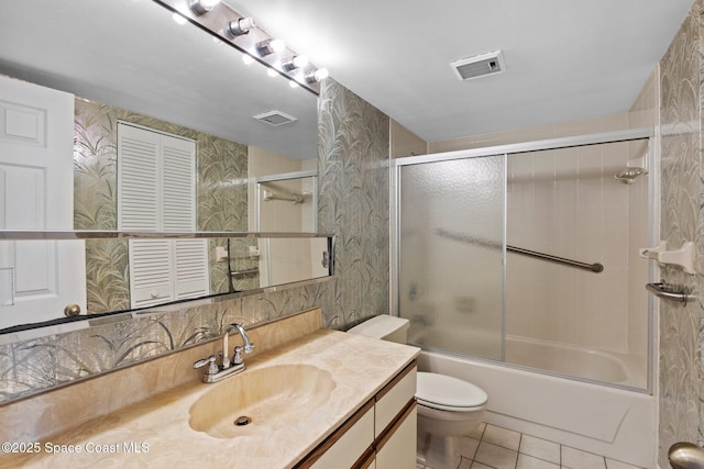 5801 N Banana River Blvd Unit 936, Cape Canaveral, FL 32920 - bathroom with tile patterned floors, shower / bath combination with glass door, toilet, vanity, and visible vents