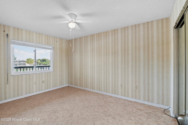 5801 N Banana River Blvd Unit 936, Cape Canaveral, FL 32920 - empty room featuring a textured ceiling, ceiling fan, wallpapered walls, and baseboards