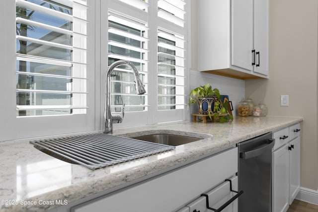 1954 Crossbill Dr, Titusville, FL 32796 - kitchen with white cabinets, backsplash, a healthy amount of sunlight, and dishwashing machine