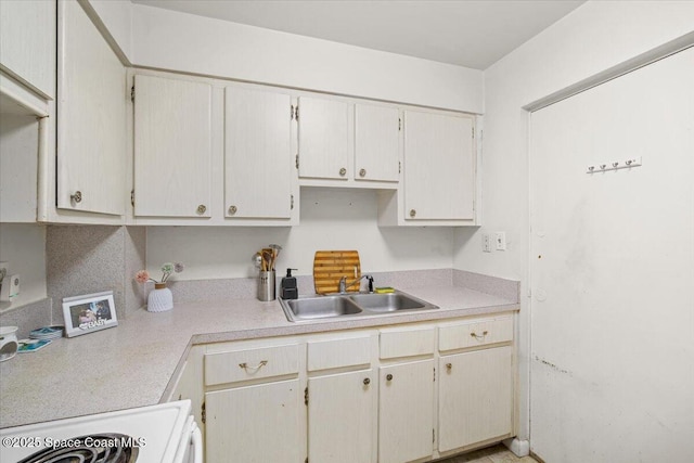 kitchen featuring light countertops and a sink