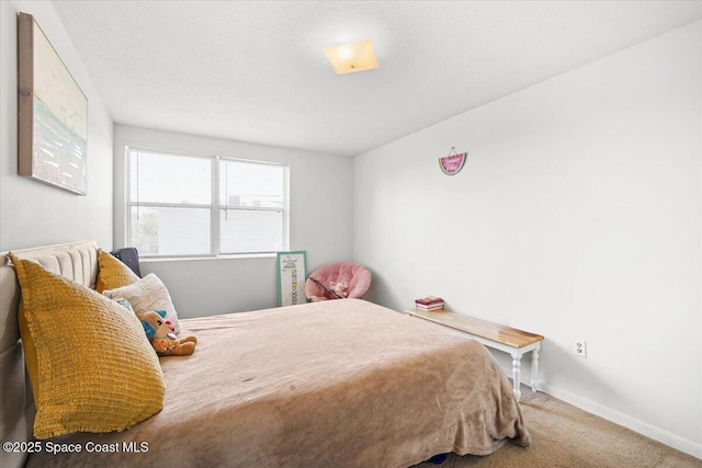 carpeted bedroom featuring baseboards