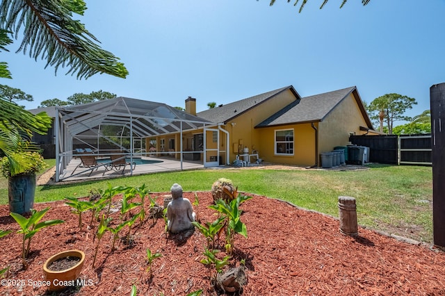 back of house featuring a fenced in pool, a patio area, a lawn, and stucco siding