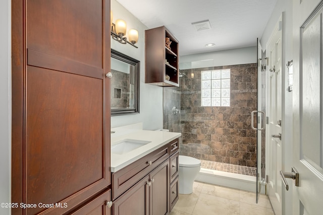 bathroom with vanity, visible vents, toilet, and a shower stall