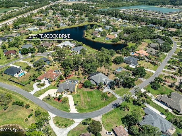 birds eye view of property featuring a water view and a residential view