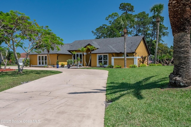 ranch-style home with french doors, curved driveway, stucco siding, and a front yard