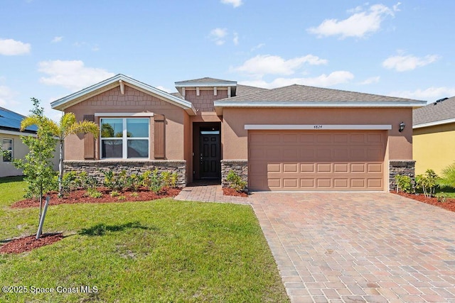 4824 Amasa Cir, Melbourne, FL 32904 - view of front of home with stucco siding, stone siding, and decorative driveway