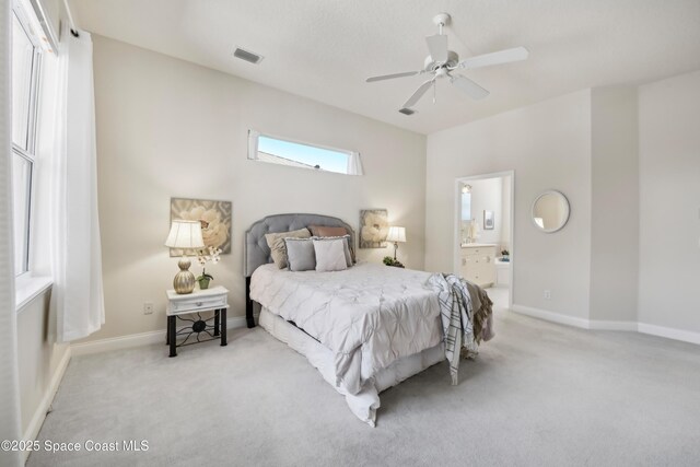 4040 Alamanda Key Dr, Melbourne, FL 32901 - bedroom with light carpet, baseboards, connected bathroom, and a ceiling fan
