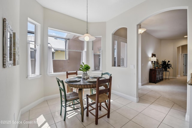 4040 Alamanda Key Dr, Melbourne, FL 32901 - dining space featuring arched walkways, light tile patterned flooring, and baseboards