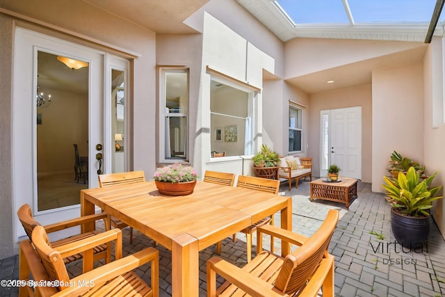 4040 Alamanda Key Dr, Melbourne, FL 32901 - dining space with brick patterned floors, lofted ceiling, a skylight, and a chandelier