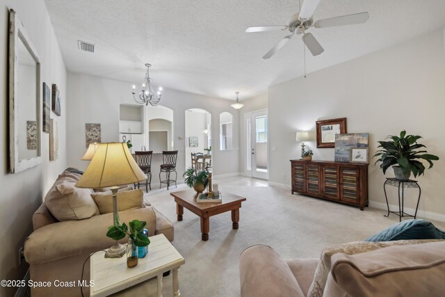 4040 Alamanda Key Dr, Melbourne, FL 32901 - living area with arched walkways, ceiling fan, light carpet, and baseboards