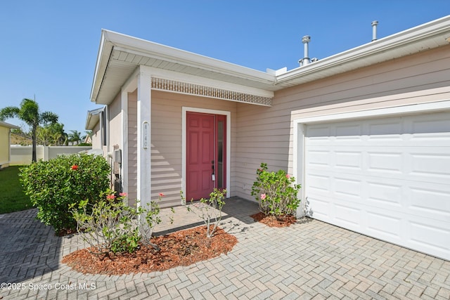 4040 Alamanda Key Dr, Melbourne, FL 32901 - doorway to property with decorative driveway and a garage