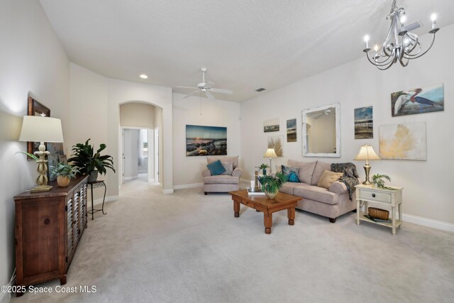 4040 Alamanda Key Dr, Melbourne, FL 32901 - living room with arched walkways, light colored carpet, a ceiling fan, baseboards, and recessed lighting