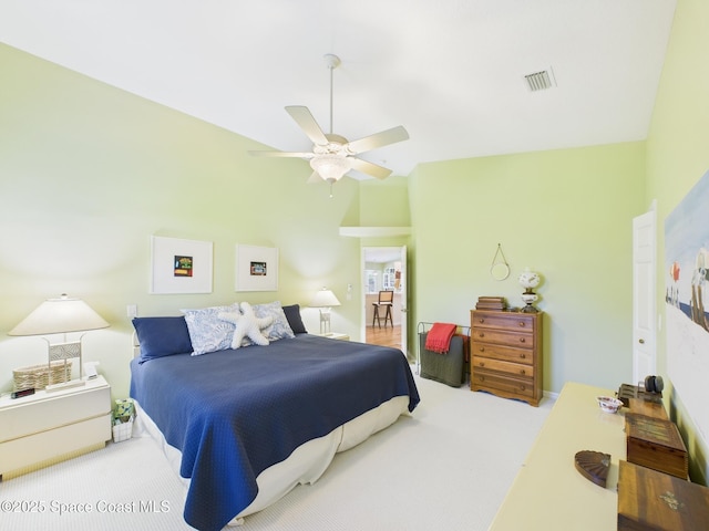 carpeted bedroom with ceiling fan, vaulted ceiling, and visible vents