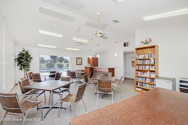 2245 Golf Isle Dr Unit 424, Melbourne, FL 32935 - dining room featuring ceiling fan, light carpet, lofted ceiling, and visible vents
