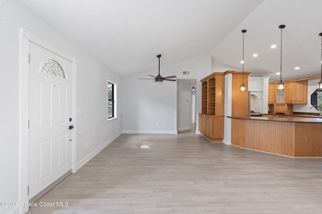 4000 Ocala St, Cocoa, FL 32926 - kitchen featuring dark countertops, a ceiling fan, light wood-type flooring, decorative light fixtures, and baseboards
