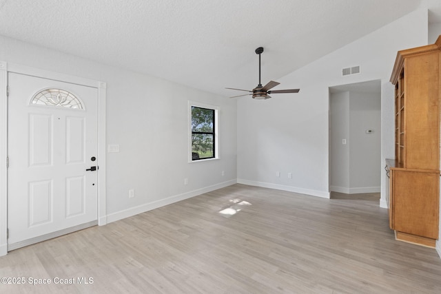 4000 Ocala St, Cocoa, FL 32926 - unfurnished living room with vaulted ceiling, a ceiling fan, light wood finished floors, baseboards, and visible vents