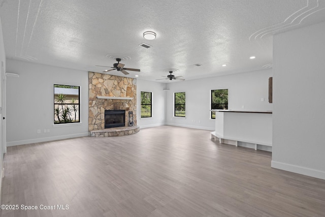 4000 Ocala St, Cocoa, FL 32926 - unfurnished living room featuring wood finished floors, a textured ceiling, baseboards, and ceiling fan