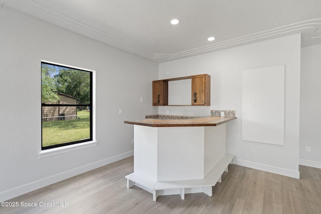 4000 Ocala St, Cocoa, FL 32926 - kitchen featuring recessed lighting, brown cabinetry, baseboards, light wood-style flooring, and a textured ceiling