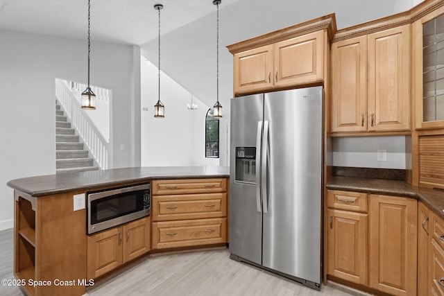 4000 Ocala St, Cocoa, FL 32926 - kitchen with lofted ceiling, stainless steel appliances, light wood-style flooring, and dark countertops