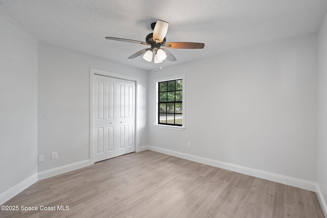 4000 Ocala St, Cocoa, FL 32926 - unfurnished bedroom featuring a textured ceiling, a closet, light wood finished floors, and baseboards