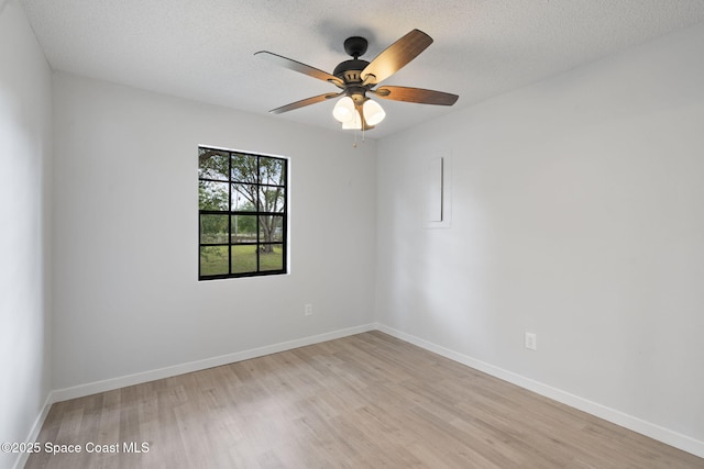 4000 Ocala St, Cocoa, FL 32926 - empty room featuring baseboards, a ceiling fan, a textured ceiling, and light wood-style flooring