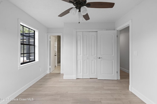 4000 Ocala St, Cocoa, FL 32926 - unfurnished bedroom with ensuite bath, baseboards, a closet, and light wood-type flooring