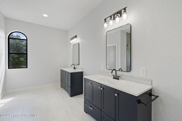 4000 Ocala St, Cocoa, FL 32926 - bathroom with two vanities, baseboards, and a sink