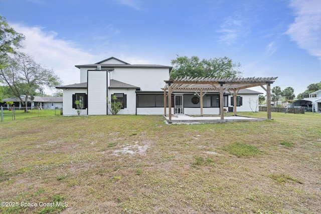 4000 Ocala St, Cocoa, FL 32926 - back of house with fence, a pergola, a yard, and stucco siding