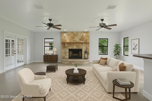 4000 Ocala St, Cocoa, FL 32926 - living room with visible vents, baseboards, a fireplace, and ceiling fan