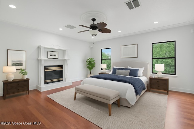 4000 Ocala St, Cocoa, FL 32926 - bedroom featuring visible vents, a glass covered fireplace, wood finished floors, and recessed lighting