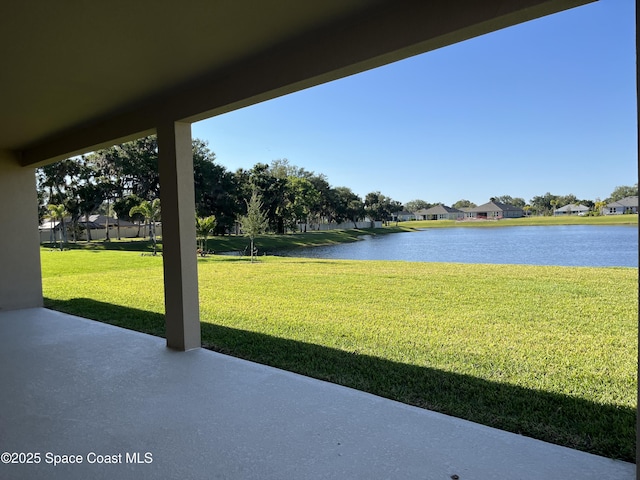 view of yard featuring a water view, a patio area, and a residential view
