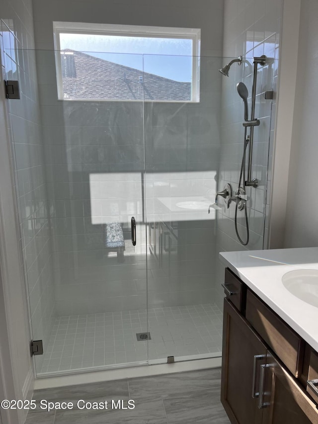 full bathroom featuring a shower stall and vanity