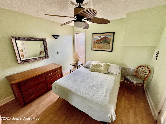 350 Taylor Ave Unit 20B1, Cape Canaveral, FL 32920 - bedroom with a ceiling fan, baseboards, a textured ceiling, and light wood-style floors