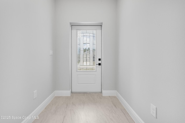 doorway featuring baseboards