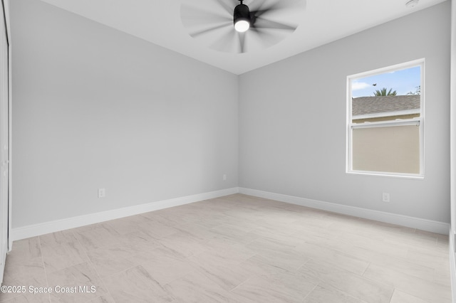 spare room featuring baseboards and ceiling fan