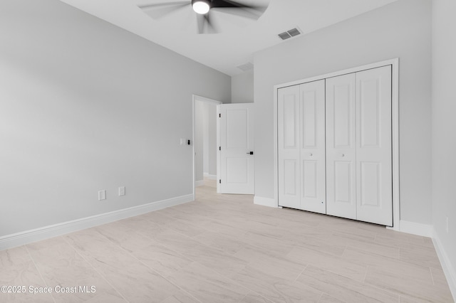 unfurnished bedroom featuring baseboards, a closet, a ceiling fan, and visible vents