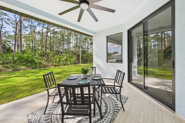 exterior space with outdoor dining space and a ceiling fan
