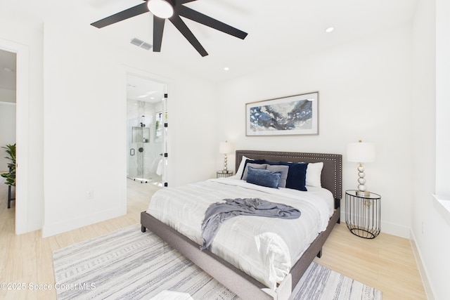 bedroom with wood finished floors, connected bathroom, ceiling fan, baseboards, and visible vents
