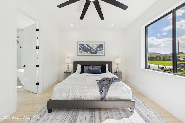 bedroom with recessed lighting, baseboards, multiple windows, and light wood-type flooring