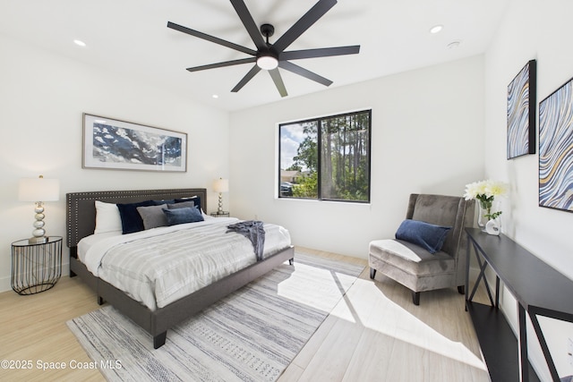 bedroom featuring a ceiling fan, wood finished floors, and recessed lighting
