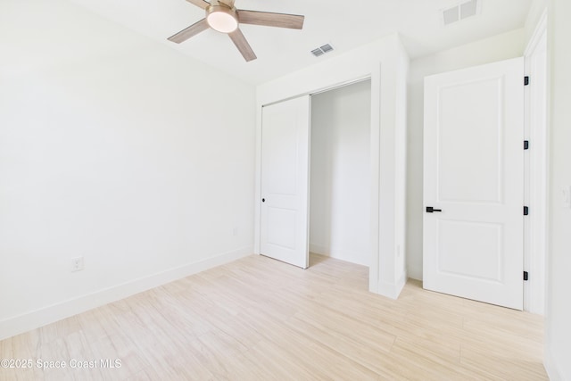 unfurnished bedroom with a closet, visible vents, and light wood finished floors